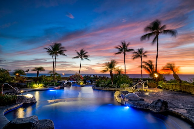 pool at dusk with a water view