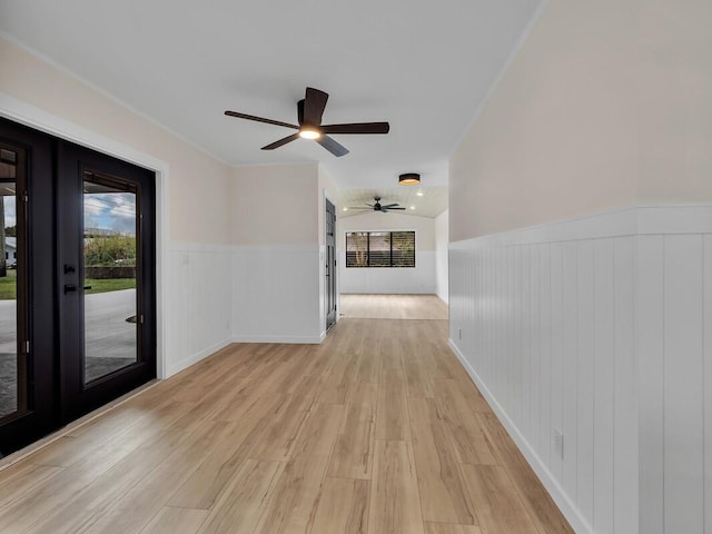 hall featuring vaulted ceiling, french doors, light hardwood / wood-style flooring, and plenty of natural light