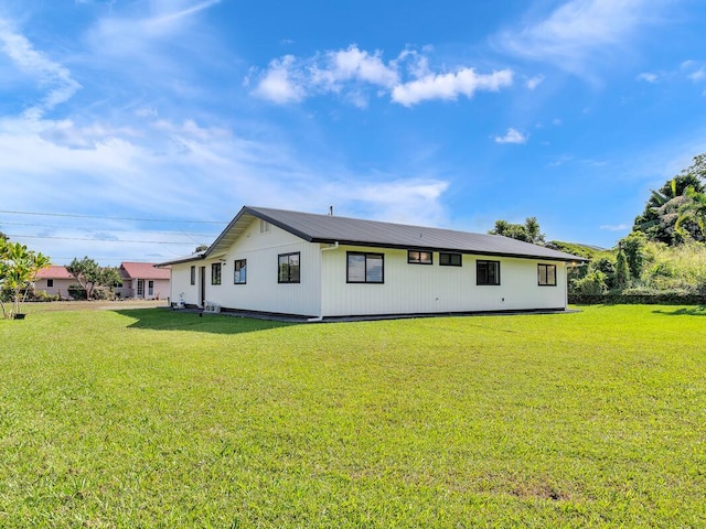 back of property featuring a lawn