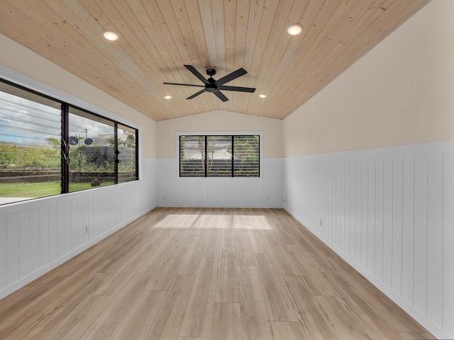 spare room with light hardwood / wood-style floors, lofted ceiling, plenty of natural light, ceiling fan, and wooden ceiling