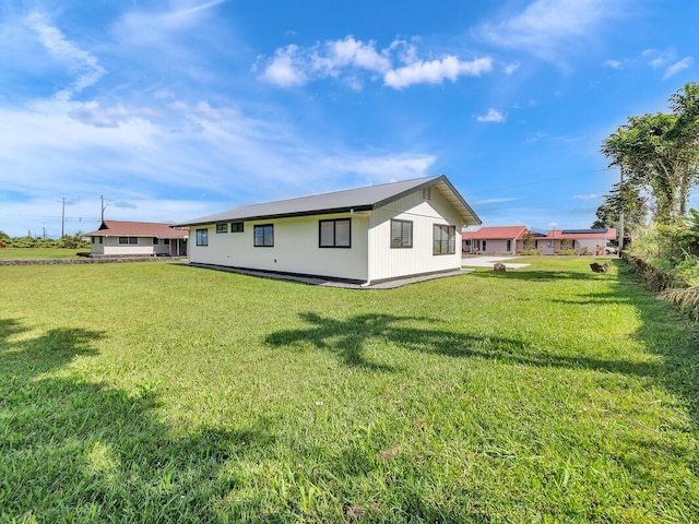 view of side of home with a lawn