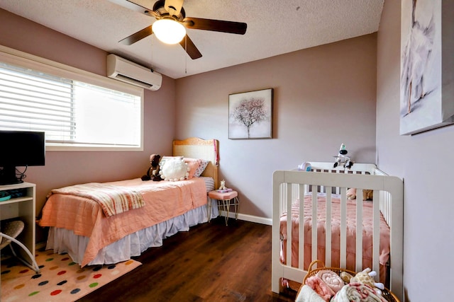 bedroom featuring a wall mounted air conditioner, a textured ceiling, dark wood-type flooring, and ceiling fan