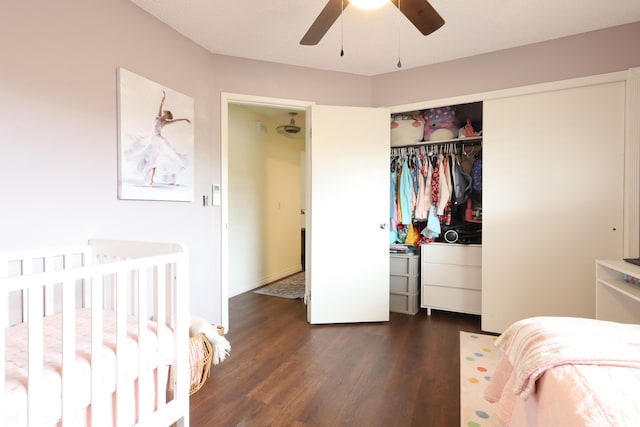 bedroom featuring dark wood-type flooring, a closet, and ceiling fan