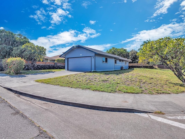 view of side of property with a garage and a yard