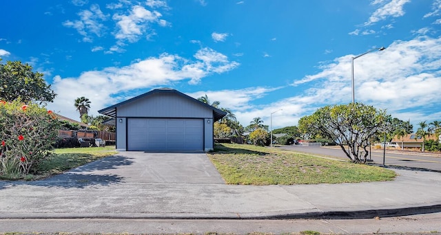 view of home's exterior with a garage and a lawn