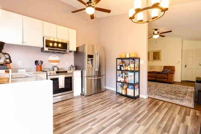 kitchen featuring ceiling fan, light hardwood / wood-style flooring, white cabinets, and appliances with stainless steel finishes