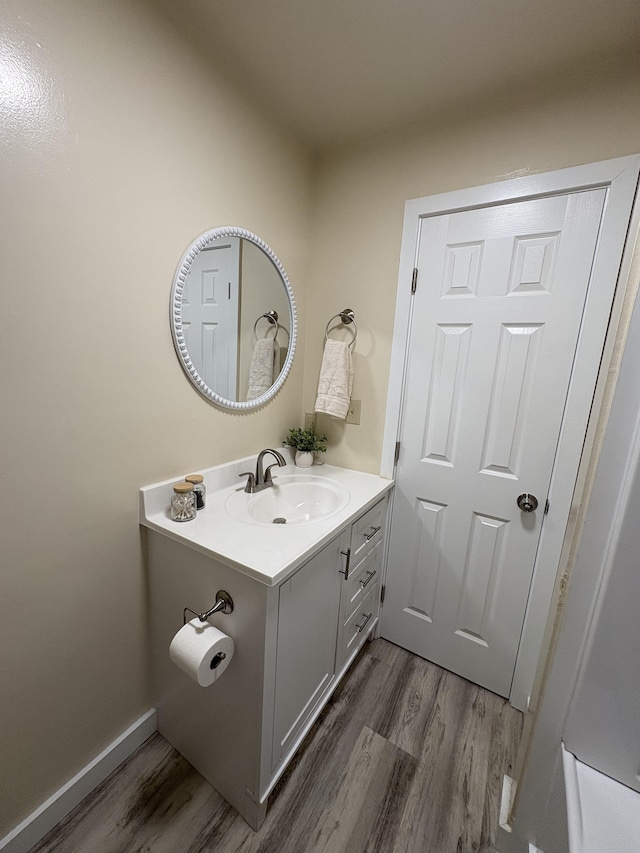 bathroom with vanity and hardwood / wood-style flooring