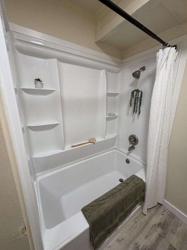 bathroom featuring hardwood / wood-style floors and shower / tub combo with curtain