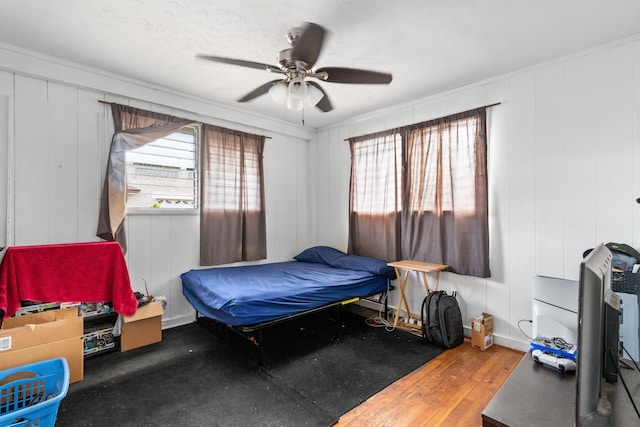 bedroom featuring ornamental molding, ceiling fan, and hardwood / wood-style floors