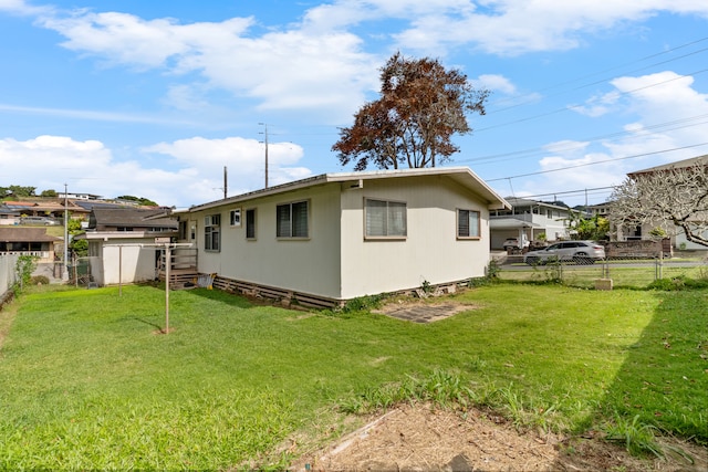 rear view of house featuring a yard