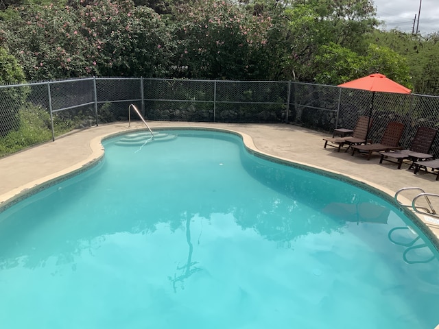 view of swimming pool with fence, a fenced in pool, and a patio