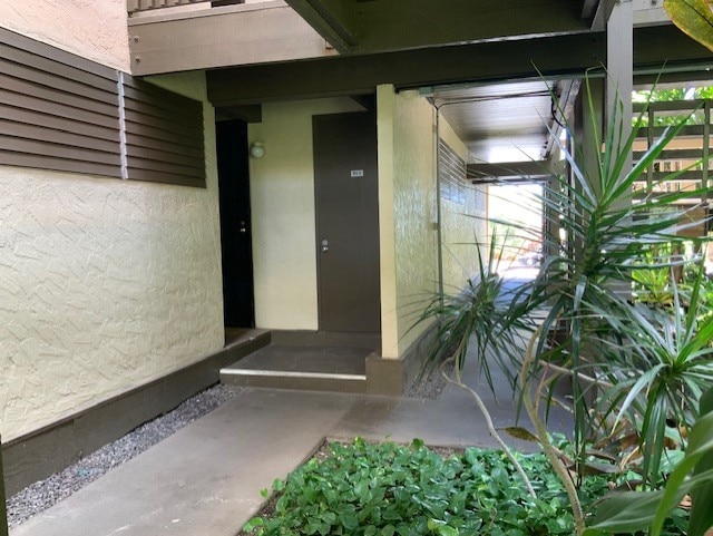 entrance to property featuring stucco siding