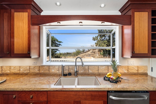 kitchen featuring sink, light stone countertops, and dishwasher