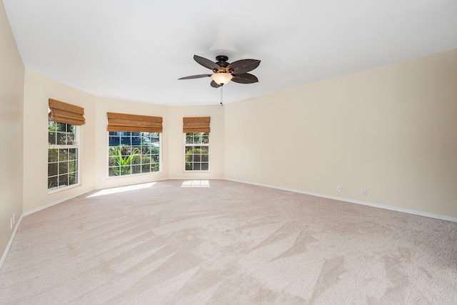 carpeted empty room featuring ceiling fan