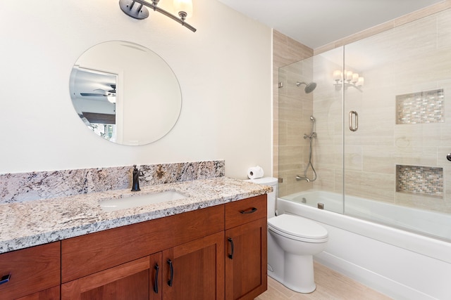 full bathroom with shower / bath combination with glass door, tile patterned floors, vanity, and toilet