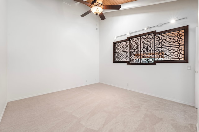 spare room featuring light colored carpet, wooden ceiling, and ceiling fan