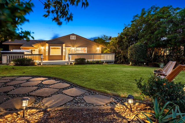 exterior space featuring a deck and a lawn