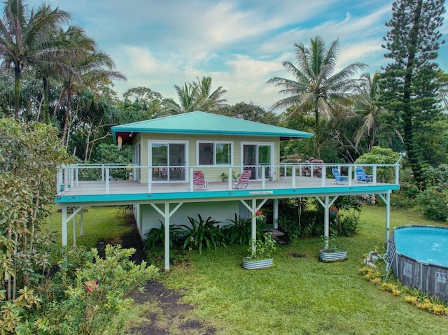 view of pool with a deck and a lawn