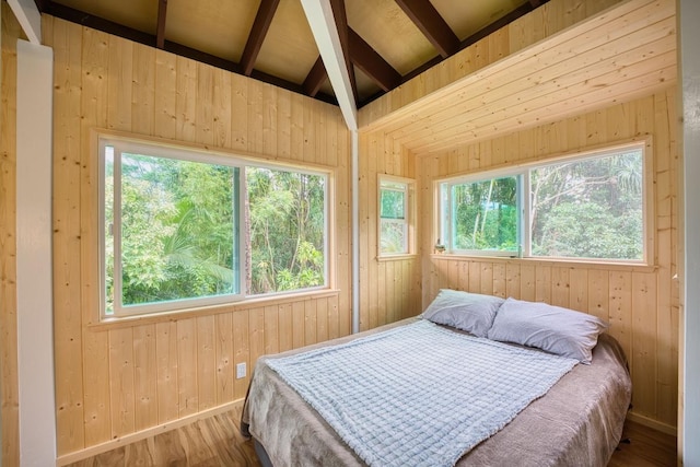 bedroom with vaulted ceiling and hardwood / wood-style floors