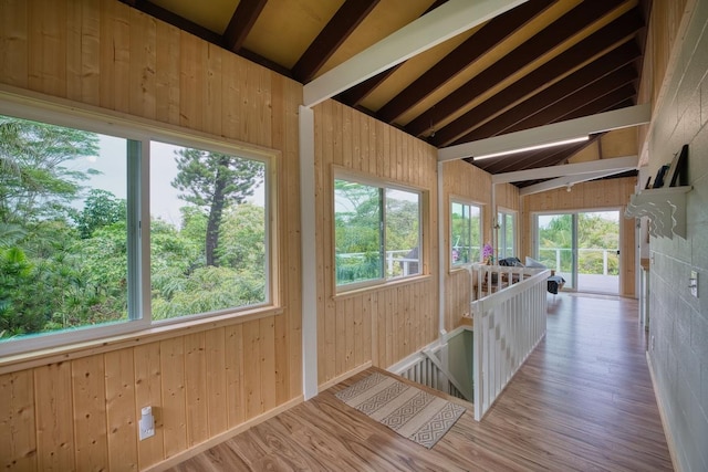 unfurnished sunroom featuring vaulted ceiling