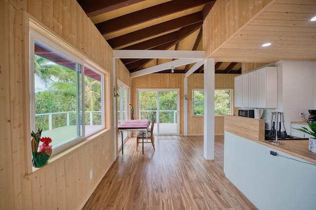 unfurnished sunroom with lofted ceiling and a healthy amount of sunlight