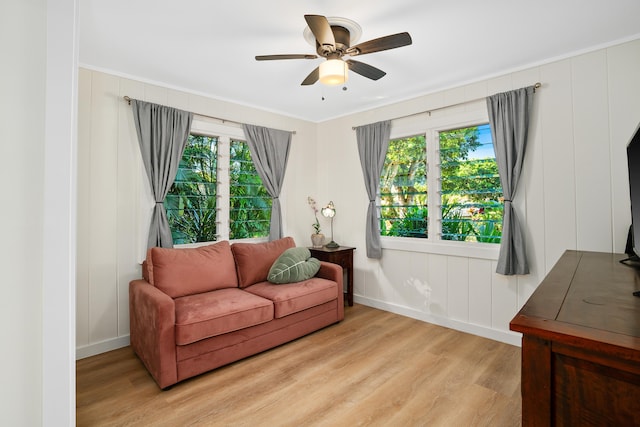 living room with light hardwood / wood-style flooring, a wealth of natural light, and ceiling fan