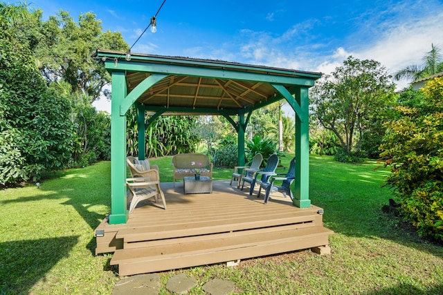 wooden deck featuring a gazebo, an outdoor hangout area, and a lawn