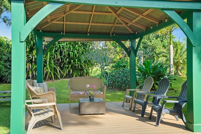 wooden deck featuring an outdoor living space, a gazebo, and a yard