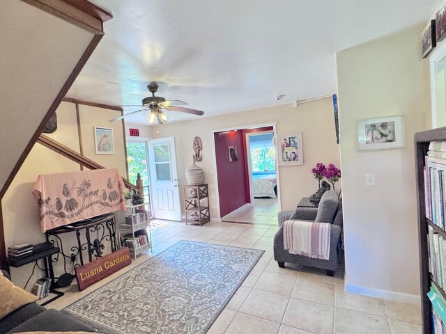 living room featuring light tile patterned floors, a wealth of natural light, and ceiling fan