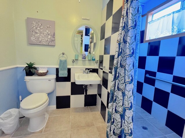 bathroom with sink, a shower with curtain, tile patterned floors, and toilet