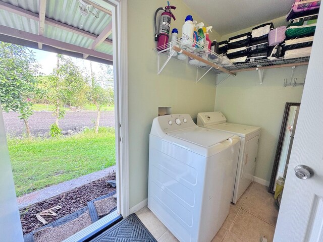 laundry area featuring light tile patterned flooring and separate washer and dryer