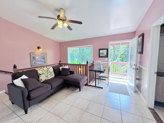 tiled living room with plenty of natural light and ceiling fan