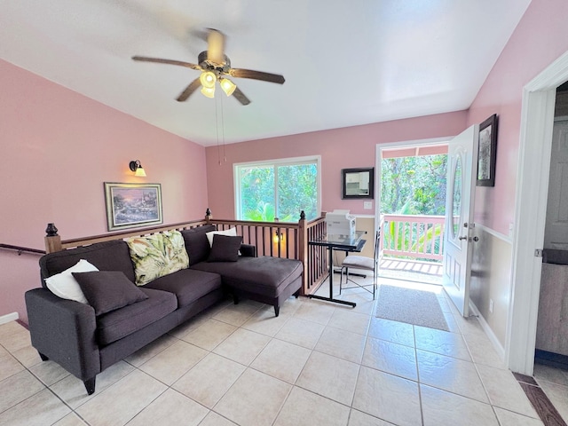 tiled living room with plenty of natural light and ceiling fan