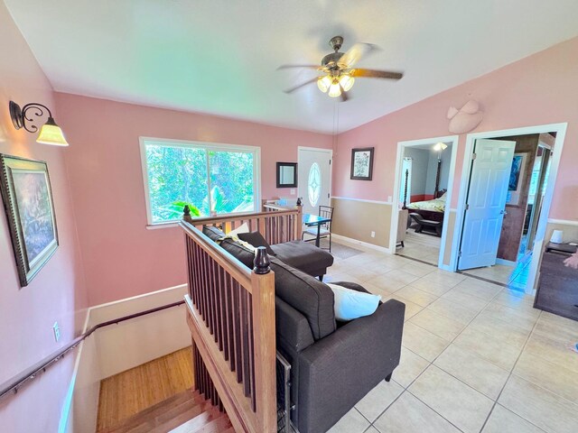 living room featuring light tile patterned floors, vaulted ceiling, and ceiling fan