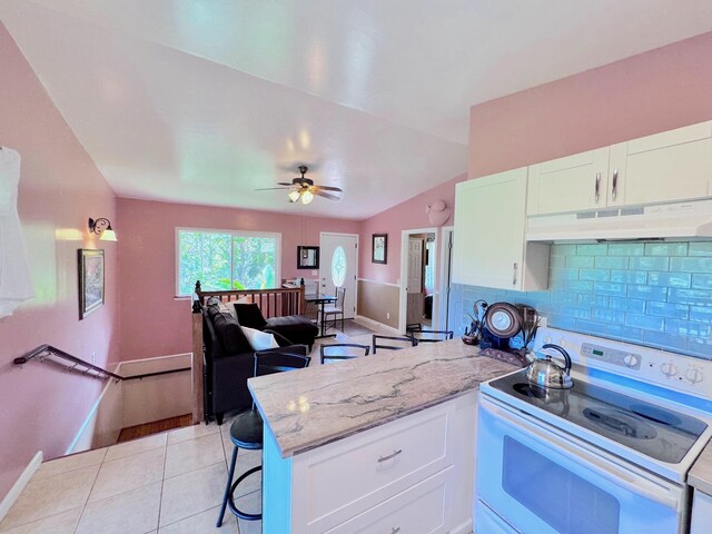 kitchen featuring light tile patterned floors, white electric range, white cabinetry, light stone counters, and tasteful backsplash