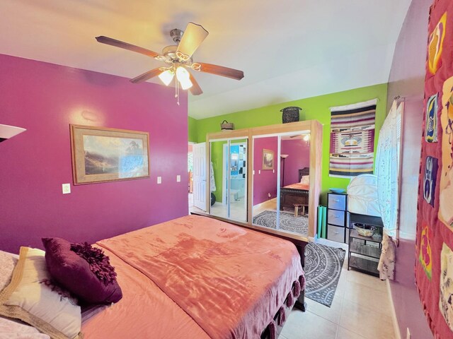 tiled bedroom featuring ceiling fan