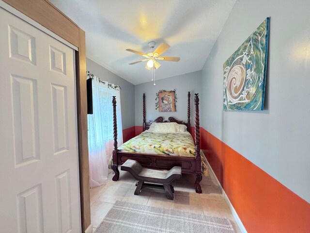 bedroom featuring light tile patterned floors and ceiling fan