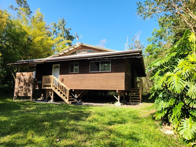 view of front of property featuring a front yard and stairs