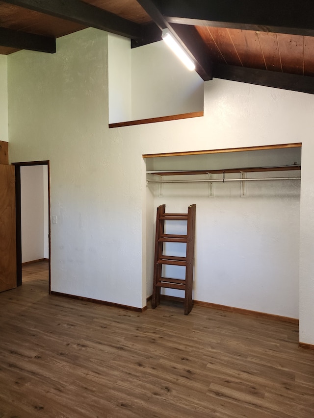 interior space featuring beamed ceiling and wood finished floors