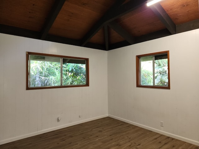 empty room with wooden ceiling, a healthy amount of sunlight, baseboards, and wood finished floors