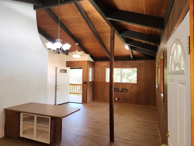 foyer featuring vaulted ceiling with beams, a notable chandelier, wooden walls, wood finished floors, and wood ceiling