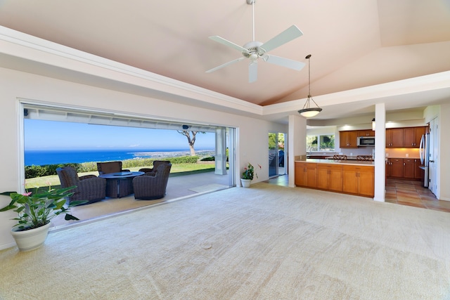 unfurnished living room featuring vaulted ceiling, light colored carpet, and ceiling fan