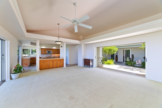 unfurnished living room with lofted ceiling, light colored carpet, and ceiling fan