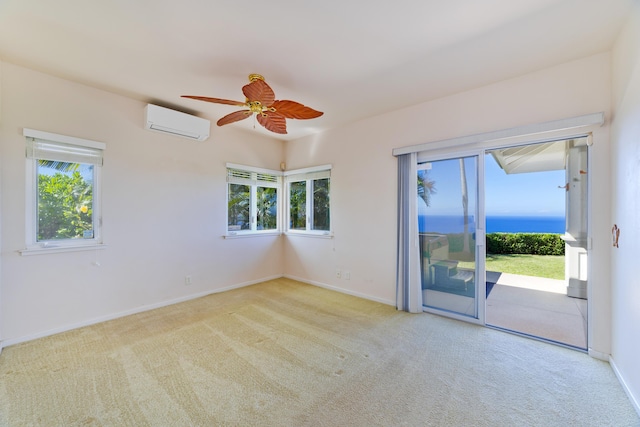 empty room featuring a healthy amount of sunlight, light carpet, and a wall unit AC