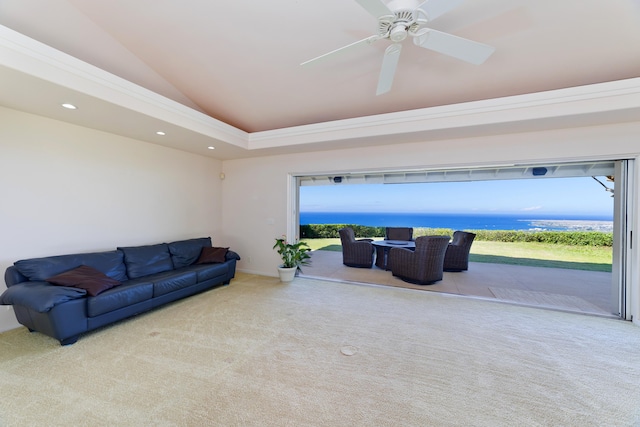 living room featuring vaulted ceiling, a water view, a wealth of natural light, and light carpet