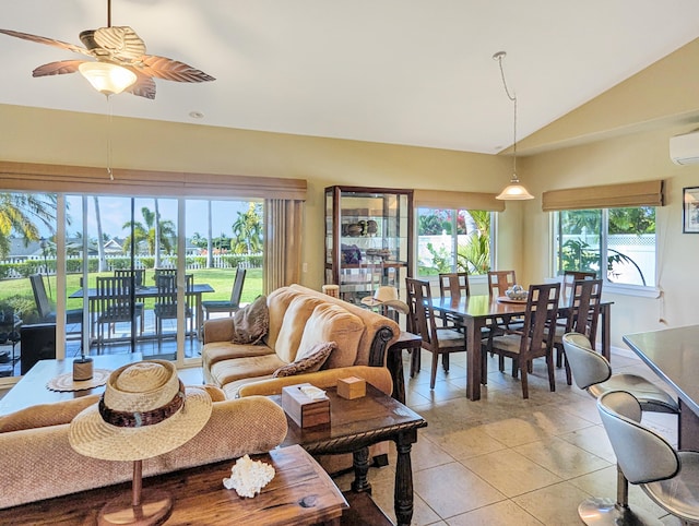 living room featuring lofted ceiling, a healthy amount of sunlight, light tile patterned floors, and ceiling fan