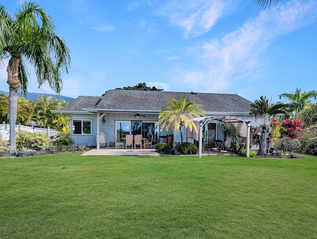 rear view of house with a yard, a pergola, and a patio area