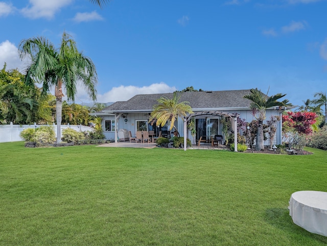 back of house featuring a pergola, a lawn, and a patio