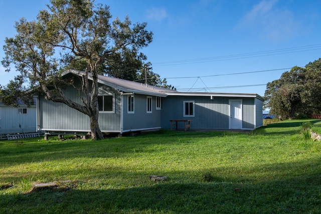 rear view of house with a lawn