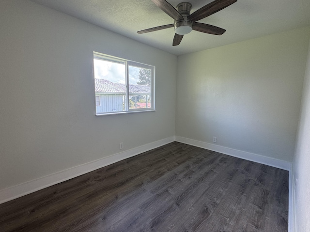 empty room featuring a textured ceiling, dark hardwood / wood-style floors, and ceiling fan